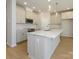 Modern kitchen featuring an island, stainless appliances, and hardwood flooring at 149 Halite Ln, Waxhaw, NC 28173