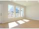 Bright, open-concept living room featuring hardwood floors and a trio of sunlit windows at 149 Halite Ln, Waxhaw, NC 28173