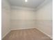 Walk in closet with wire shelving and neutral carpet at 149 Halite Ln, Waxhaw, NC 28173