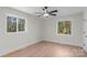 Spacious bedroom with two windows and a ceiling fan at 7324 Pleasant Grove Rd, Charlotte, NC 28216