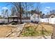 Backyard featuring a fire pit and gazebo, surrounded by a manicured lawn at 8007 April Ln, Matthews, NC 28104