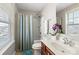 Bright bathroom with white fixtures, a shower-tub combo and a window at 8007 April Ln, Matthews, NC 28104