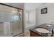 Modern bathroom featuring a glass enclosed shower, soaking tub, and dual sink vanity at 8007 April Ln, Matthews, NC 28104