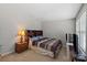 Bedroom showcasing a queen bed, wood nightstand, and a matching wood headboard at 8007 April Ln, Matthews, NC 28104
