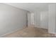 A spacious bedroom with neutral carpeting and paint offers a blank canvas at 8007 April Ln, Matthews, NC 28104