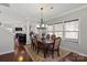 Elegant dining area with hardwood floors and a chandelier, open to the living room at 8007 April Ln, Matthews, NC 28104