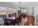Elegant dining room featuring hardwood floors and large windows offering plenty of natural light at 8007 April Ln, Matthews, NC 28104