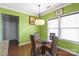 Bright dining room with a glass table, seating for four, and large windows for natural light at 8007 April Ln, Matthews, NC 28104