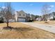 Inviting two-story home featuring stone accents and a two-car garage with a well-manicured lawn at 8007 April Ln, Matthews, NC 28104