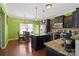 Modern kitchen with stainless steel appliances, granite countertops, dark cabinets and a breakfast nook at 8007 April Ln, Matthews, NC 28104