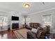 Inviting living room with a fireplace, hardwood floors, comfortable leather seating and natural light at 8007 April Ln, Matthews, NC 28104