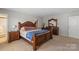 Large main bedroom with a king-size bed, furniture set, and neutral carpet at 8007 April Ln, Matthews, NC 28104