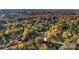 Aerial view of a home nestled among colorful fall foliage within a vibrant residential neighborhood at 841 12Th Nw Ave, Hickory, NC 28601
