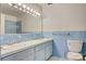 Bathroom with blue tile, double sinks, updated lighting and hardware at 841 12Th Nw Ave, Hickory, NC 28601