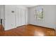 Bedroom featuring hardwood floors, closet, and natural light streaming through the window at 841 12Th Nw Ave, Hickory, NC 28601