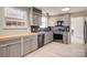 Updated kitchen with grey cabinetry, stainless steel appliances, black countertops, and light wood flooring at 841 12Th Nw Ave, Hickory, NC 28601