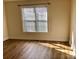 Sunlit bedroom features hardwood floors and a window offering natural light at 120 W Edinburgh Ct, Statesville, NC 28625