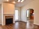 Cozy living room featuring hardwood floors, fireplace, and archway to kitchen at 120 W Edinburgh Ct, Statesville, NC 28625