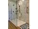 Modern bathroom shower with marble tile, glass doors, and safety handles at 120 W Edinburgh Ct, Statesville, NC 28625