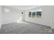 Bright bedroom with a large window and neutral carpeting to complement any design style at 15008 Brownleigh Ln # 29, Huntersville, NC 28078