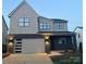 Beautiful two-story home with a modern garage door and complementary black brick and siding at 15008 Brownleigh Ln # 29, Huntersville, NC 28078
