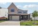 Two-story home featuring a brick facade, a two-car garage, and a manicured front lawn at 15008 Brownleigh Ln # 29, Huntersville, NC 28078