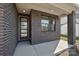 Close-up of the home's front porch showing the brick facade and modern door at 15008 Brownleigh Ln # 29, Huntersville, NC 28078