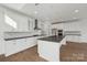 Modern kitchen featuring white cabinets, dark countertops, and a center island at 15008 Brownleigh Ln # 29, Huntersville, NC 28078