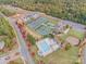 Overhead view of the tennis courts, pool and clubhouse situated within mature trees in the neighborhood at 17712 Yarwill Ct, Charlotte, NC 28278