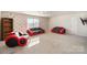 Spacious bonus room with red couches and a built-in shelf at 17712 Yarwill Ct, Charlotte, NC 28278