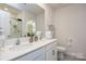 Well-lit bathroom featuring a double sink vanity, framed mirror and updated fixtures, offering a modern aesthetic at 318 Kingsford Dr, Stanley, NC 28164