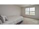 Cozy bedroom with a comfortable bed, soft carpet, and natural light, offering a relaxing retreat at 318 Kingsford Dr, Stanley, NC 28164