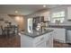 Open kitchen featuring an island, stainless steel appliances, and a dining area nearby at 318 Kingsford Dr, Stanley, NC 28164