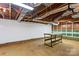 Unfinished basement with exposed ceiling, workbench, and built-in storage at 4501 Taylorsville Hwy, Statesville, NC 28625