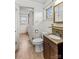 Bathroom featuring a vanity with granite countertop, toilet, and access to laundry area at 4501 Taylorsville Hwy, Statesville, NC 28625