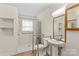 Accessible bathroom features a roll-in shower, grab bars, and pedestal sink at 4501 Taylorsville Hwy, Statesville, NC 28625
