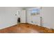 Bright bedroom featuring hardwood floors and an ensuite bathroom at 4501 Taylorsville Hwy, Statesville, NC 28625