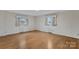 Bright bedroom with wood floors, neutral walls, and two windows providing ample natural light at 4501 Taylorsville Hwy, Statesville, NC 28625