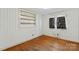 Inviting bedroom with wood floors, built-in shelving, and a window providing natural light at 4501 Taylorsville Hwy, Statesville, NC 28625