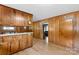 Kitchen with wood paneling, bright countertops, and a view into another room, offering a practical layout at 4501 Taylorsville Hwy, Statesville, NC 28625