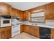 Functional kitchen featuring wood cabinets, white countertops, and a range of appliances at 4501 Taylorsville Hwy, Statesville, NC 28625