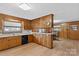 Functional kitchen featuring wood cabinets, laminate countertops, and bright lighting at 4501 Taylorsville Hwy, Statesville, NC 28625