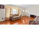 Cozy living room featuring hardwood floors, a comfortable couch and natural light from a window at 4501 Taylorsville Hwy, Statesville, NC 28625