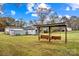 Spacious yard featuring a charming swing set and outbuildings, perfect for enjoying the outdoors at 4501 Taylorsville Hwy, Statesville, NC 28625