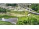Aerial view of neighborhood amenities, including a pool, playground, and pond at 654 Saddlebred Ln, Locust, NC 28097
