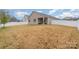 A backyard with a well-maintained lawn and a white fence enclosing the property at 654 Saddlebred Ln, Locust, NC 28097
