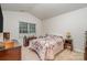 Cozy bedroom with a floral comforter, coordinating lamps, and wood furniture at 654 Saddlebred Ln, Locust, NC 28097