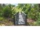 Charming foot bridge over a small ravine, surrounded by lush foliage and a peaceful, natural setting at 654 Saddlebred Ln, Locust, NC 28097