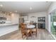 Open concept dining area next to the kitchen, with hardwood floors and access to backyard at 654 Saddlebred Ln, Locust, NC 28097