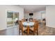 Bright dining area connected to the living room, featuring hardwood flooring and natural light at 654 Saddlebred Ln, Locust, NC 28097